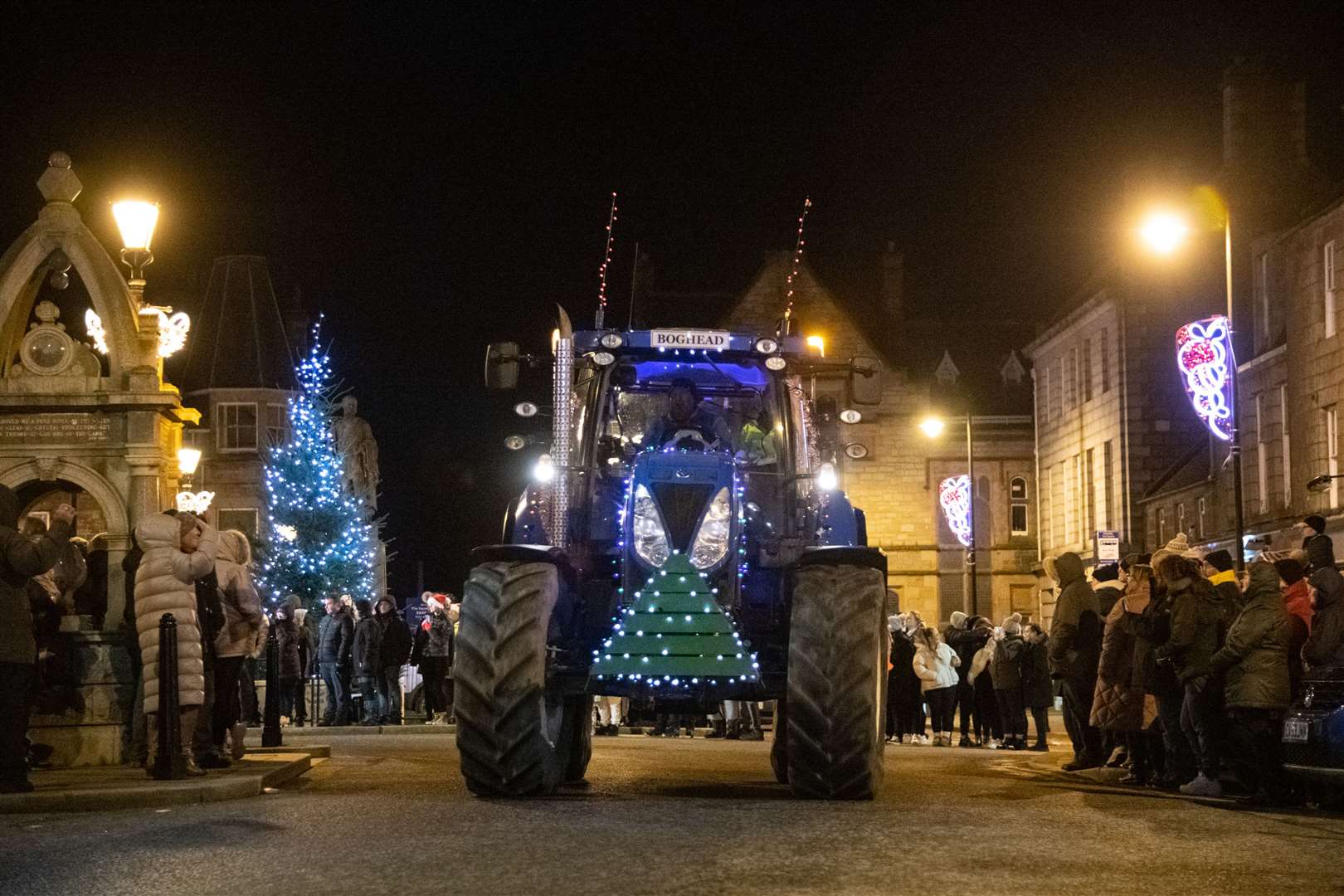 The Huntly Christmas Eve Tractor Run 2023 passes through the Sqaure in Huntly at the start of the night. ..Picture: Daniel Forsyth..