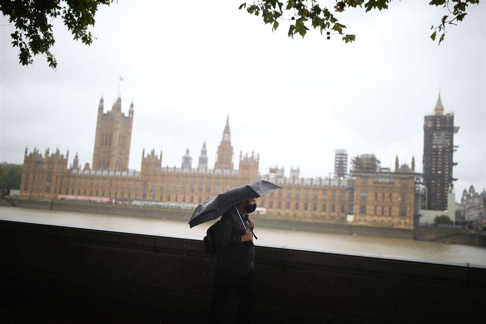 Umbrellas at the ready near the Houses of Parliament in London (Aaron Chown/PA)