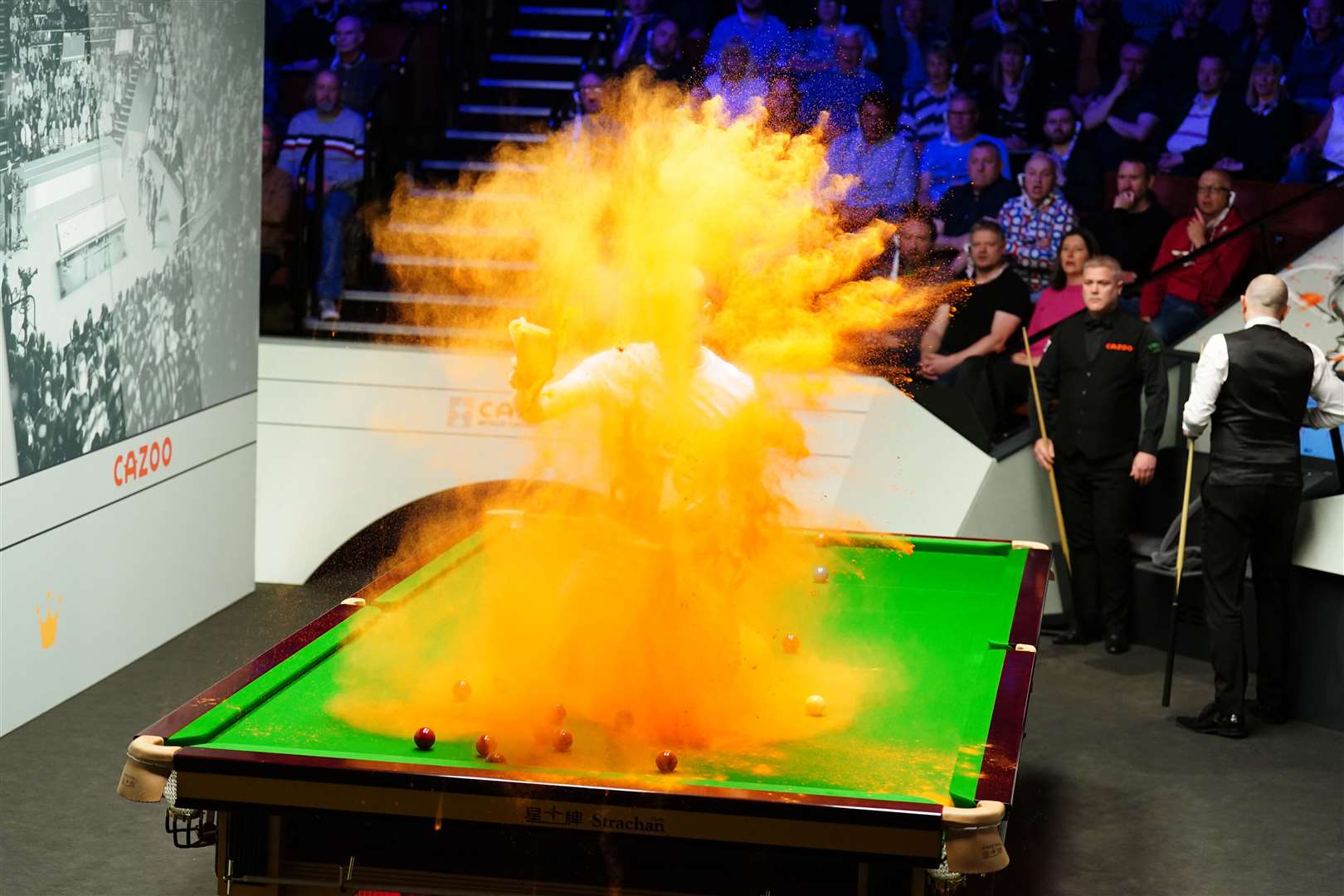 A Just Stop Oil protester throws orange powder at the Crucible in Sheffield (Mike Egerton/PA)