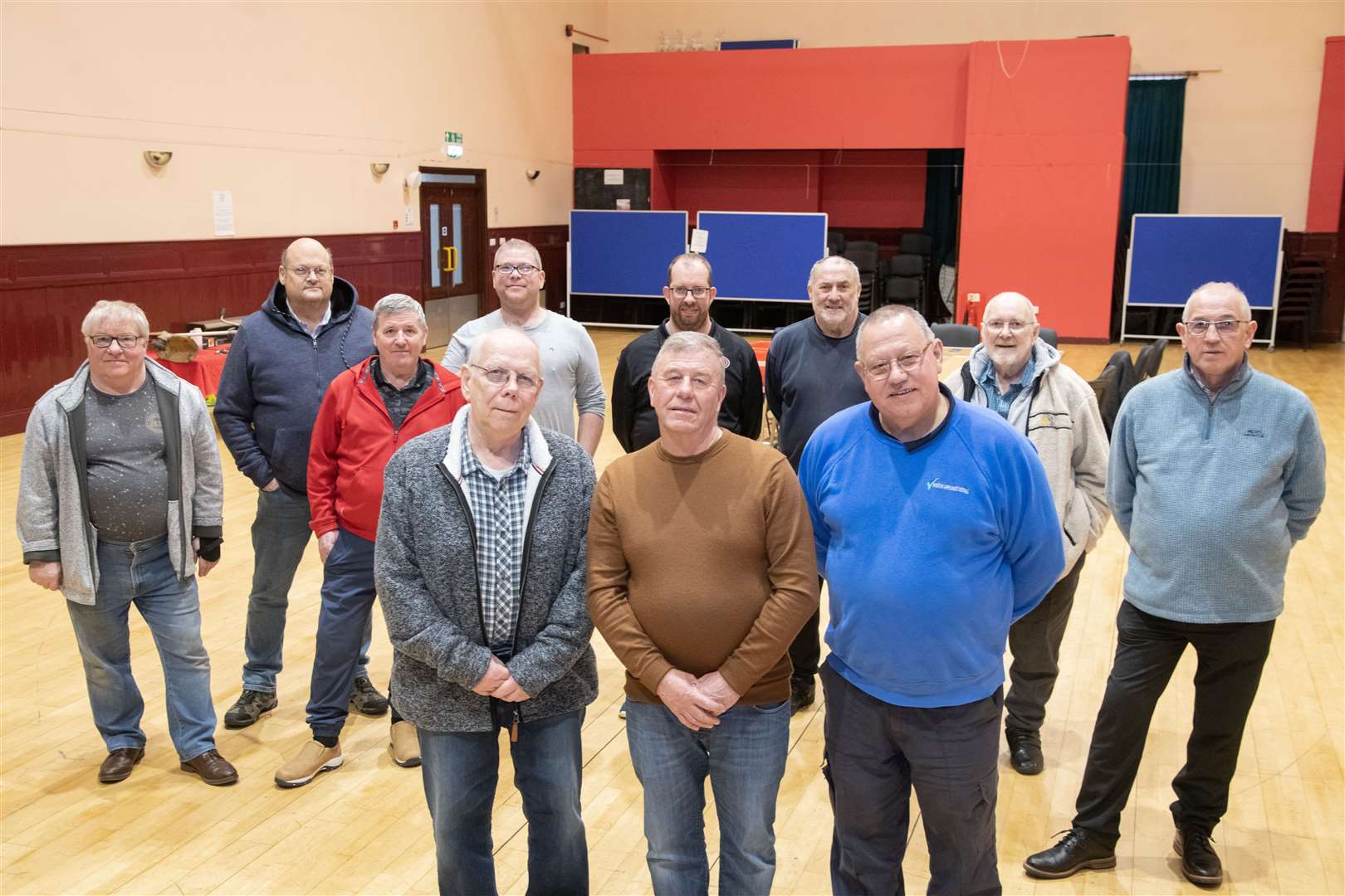 Buckie Men's Shed chairman (front right), vice-chairman Bill Cooper (front left) and secretary John Wilson (front centre) are joined by other group members in their temporary Fishermen's Hall base. Picture: Beth Taylor
