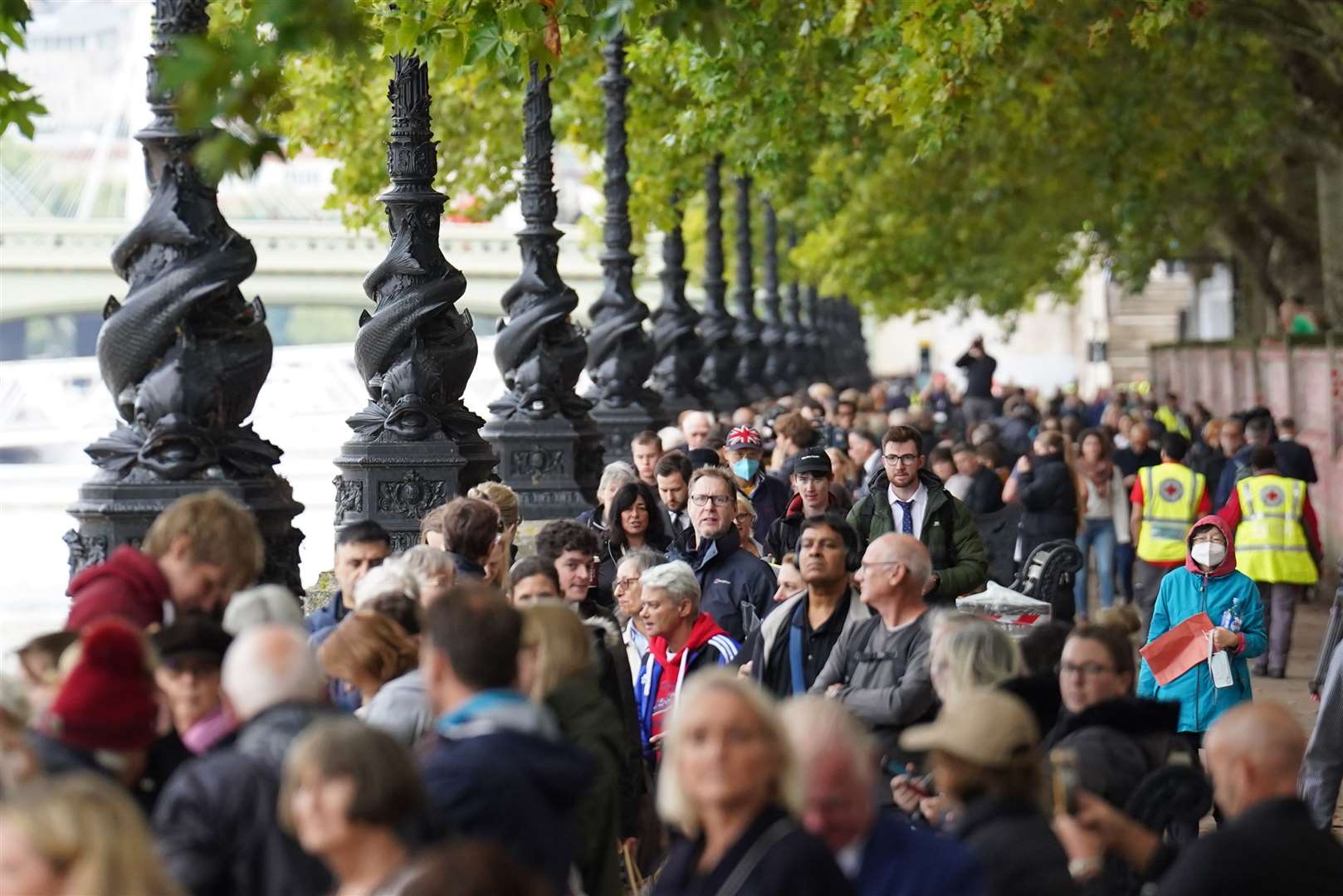 Members of the public join the queue on the South Bank, as they wait to view the Queen lying in state ahead of her funeral on Monday (Stefan Rousseau/PA)