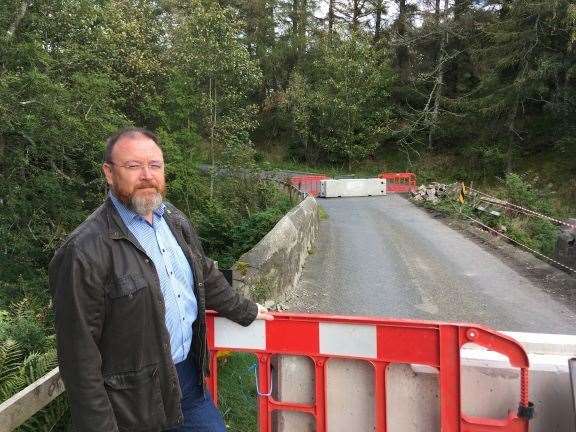 Banff and Buchan MP David Duguid at the bridge at Auchmill, which will reopen a week early.