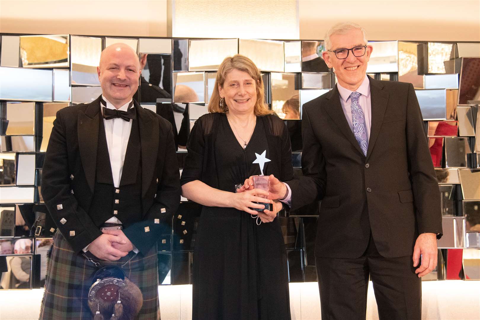 Dr Alison Barbour and Dr Iain Brooker accept the Healthcare Hero award from Peter Taylor of Specsavers. Picture: Daniel Forsyth