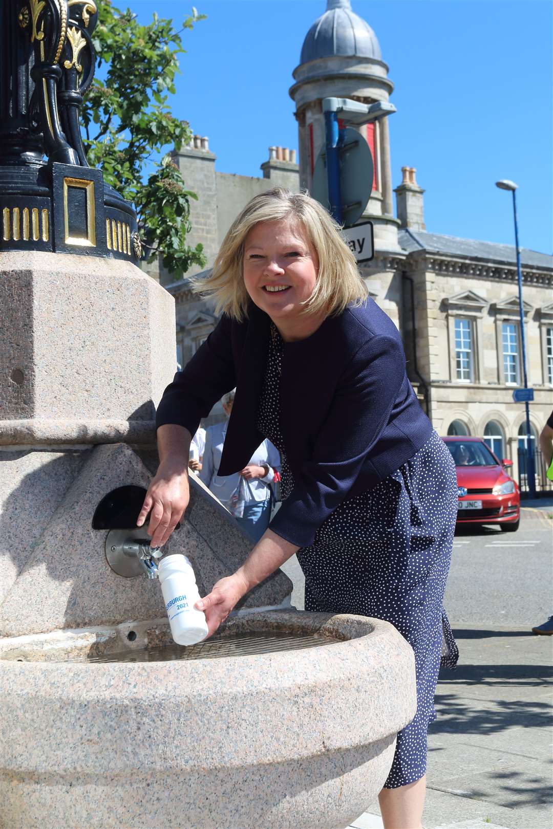 Provost Judy Whyte draws the first water from the fountain . Picture: David Porter