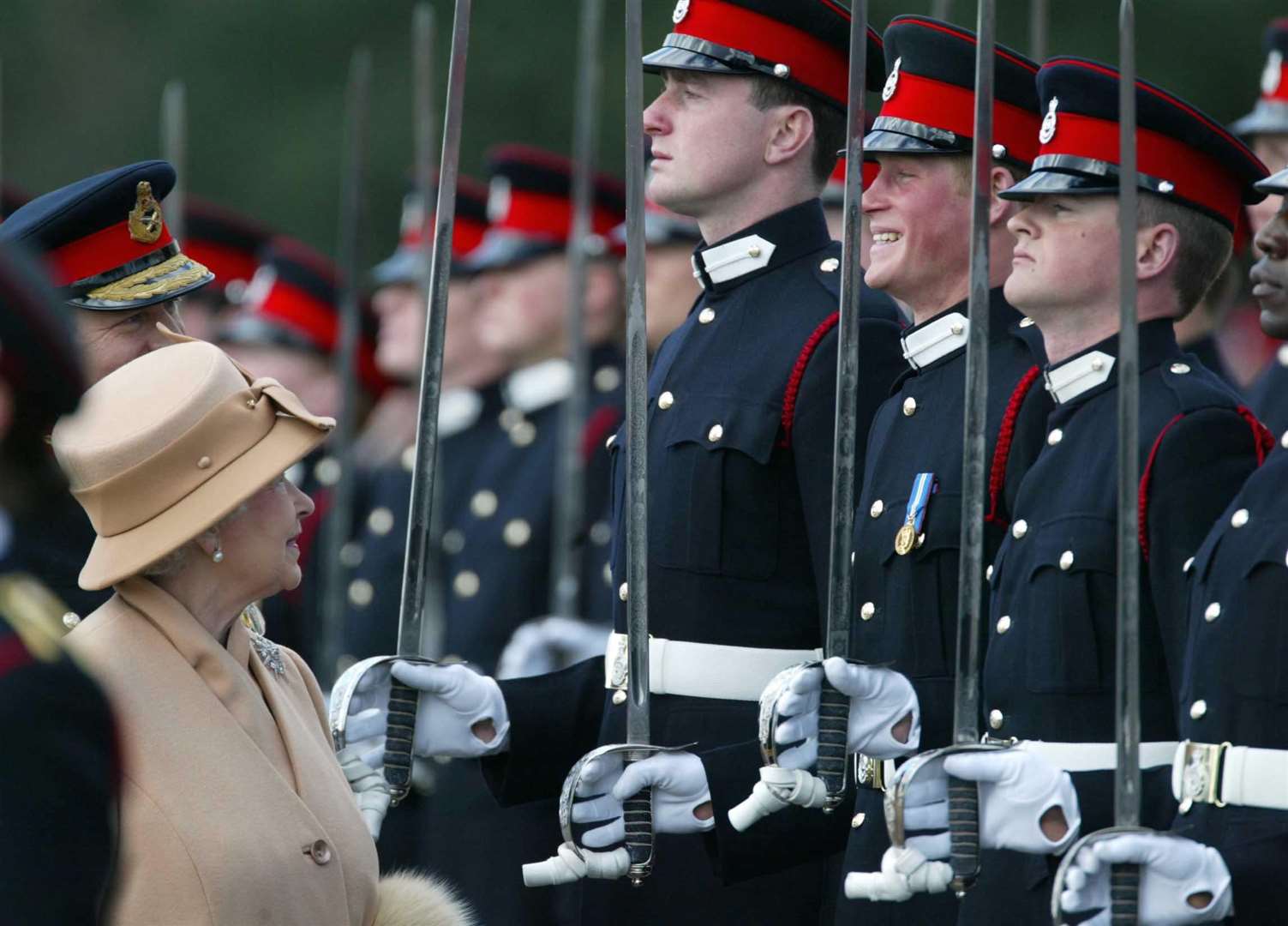 Harry smiles as his grandmother, the Queen, reviews him and other officers during the Sovereign’s Parade at the Royal Military Academy Sandhurst (James Vellacott/PA)