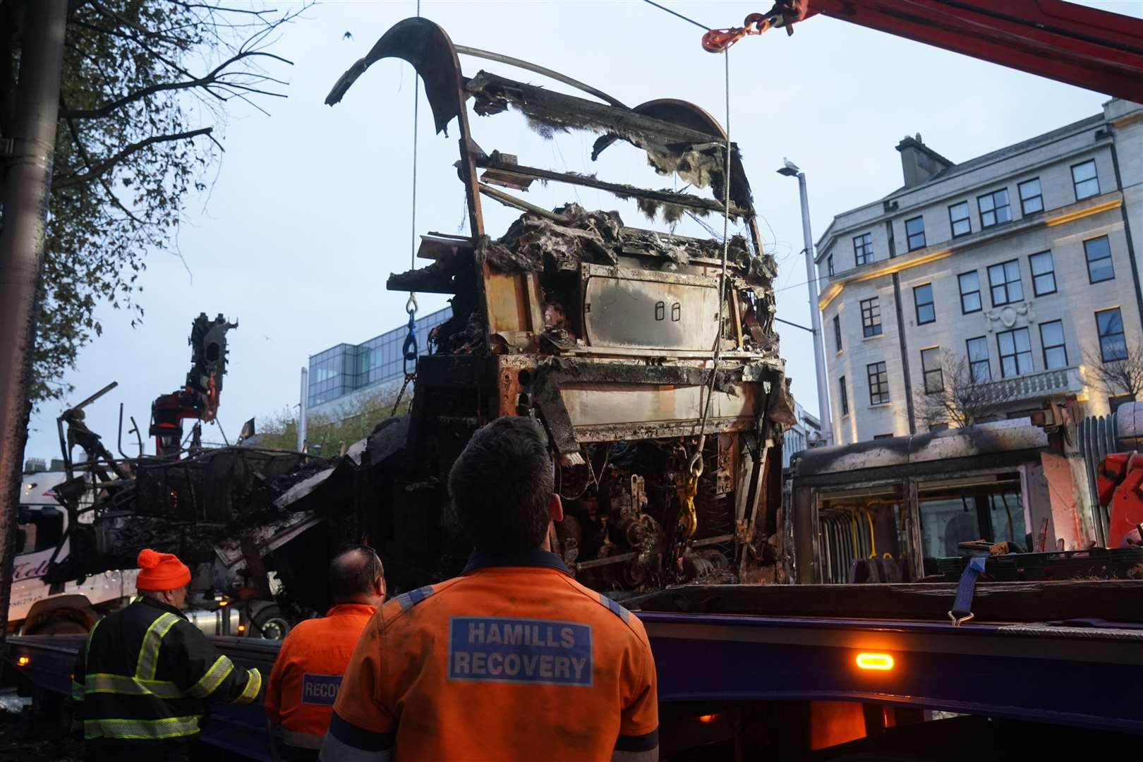 A burned out Luas is removed from O’Connell Street in Dublin (Brian Lawless/PA)