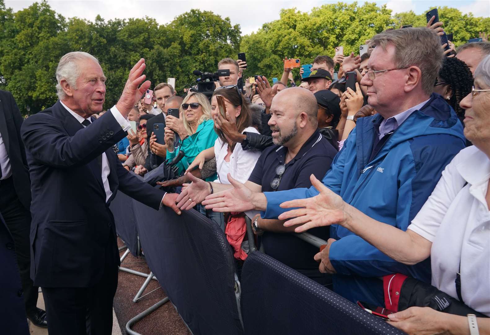Charles is greeted by well-wishers during a walkabout to view tributes left outside Buckingham Palace (Yui Mok/PA(