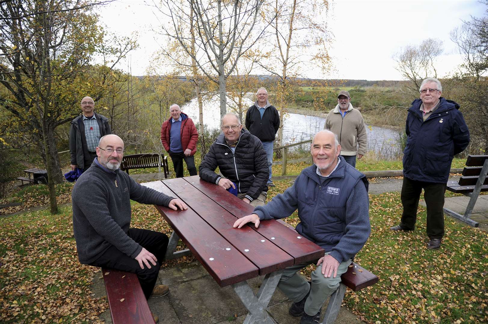 Fochabers Men's Shed group have renovated the picnic tables at the Fochaberian Memorial Gardens. Seated on the bench from left to right are Nick Chambers (Moray College), Mark Pilkington (Chairman of the Men's Shed Group) and George McIntyre (Baxtres trustee). Standing from left to tight at the back are John Howie, Dave Thow, Peter Milne, John Wright and Alex Hume. Picture: Eric Cormack