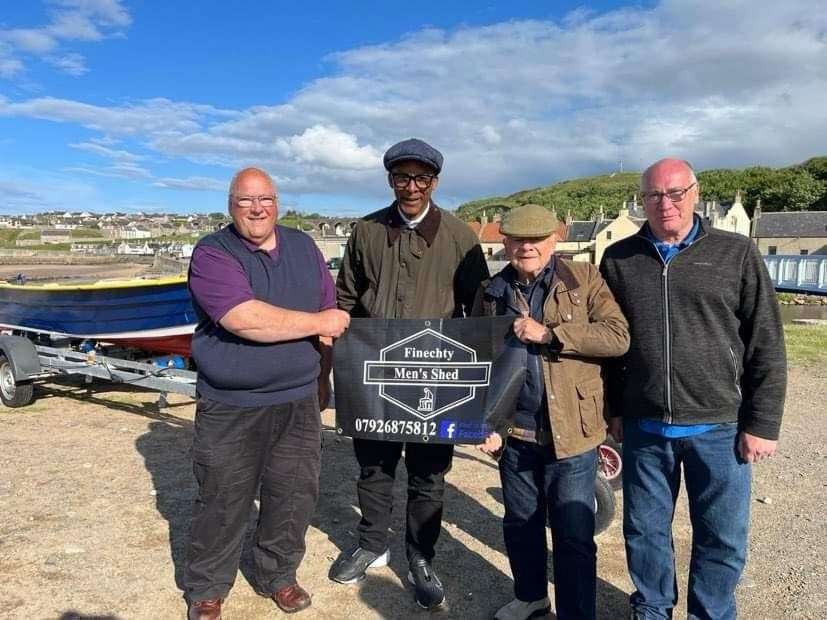 Sir David Jason and Jay Blades show off the Finechty Men's Shed banner, joined by Jimmy Bremner (left) and John Begg. Picture: Finechty Men's Shed