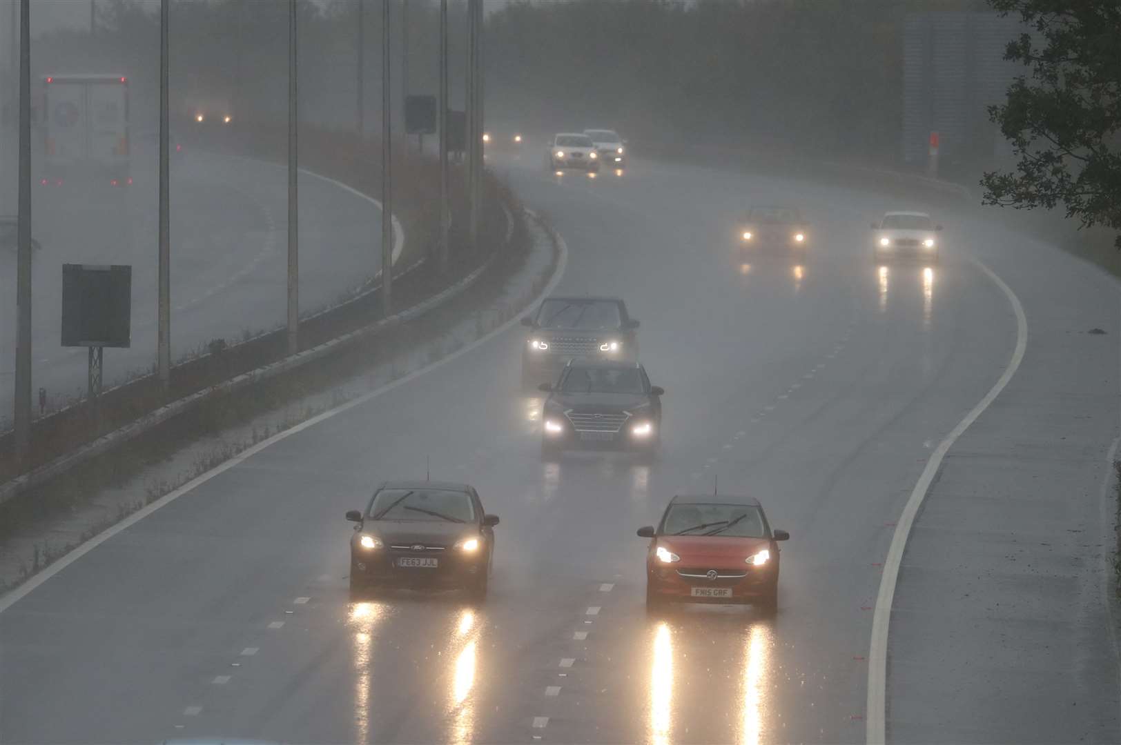 Cars drive through the rain on the M20 in Folkestone, Kent (Gareth Fuller/PA)