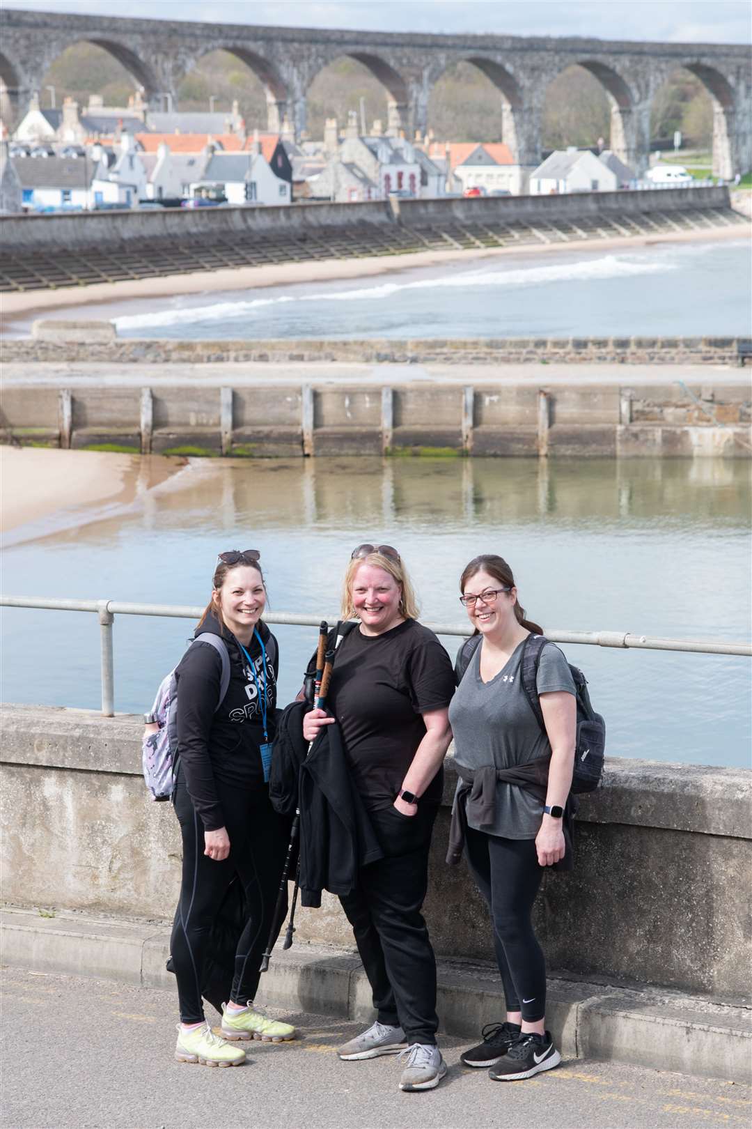 A trio of friends pause for a photo with the iconic Cullen viaducts in the background. Picture: Daniel Forsyth