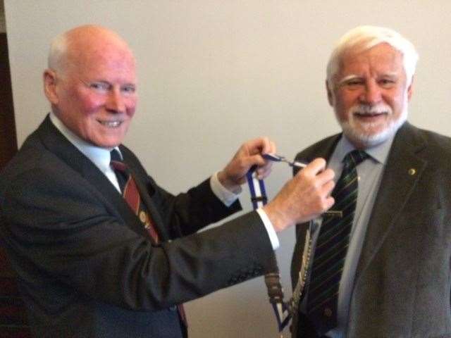Victor Joihnston handing over his chain of office to new President Graham Ritchie