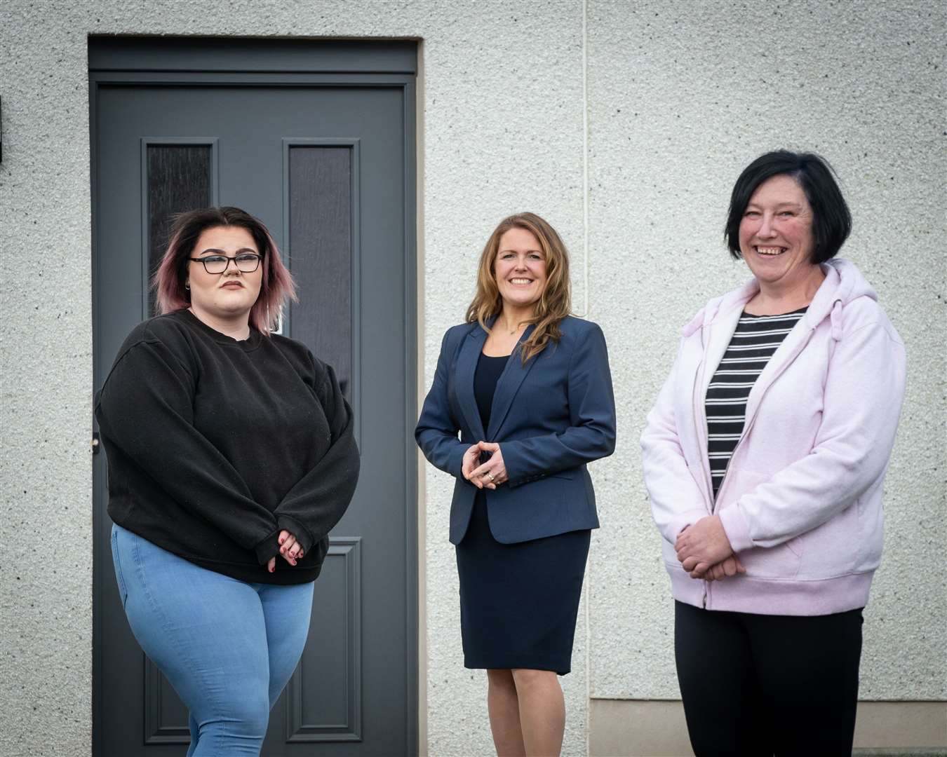 Osprey Housing Manager Stacy Angus (centre) with Isla and Jane Allan stand outside their new home at Portstown, Inverurie