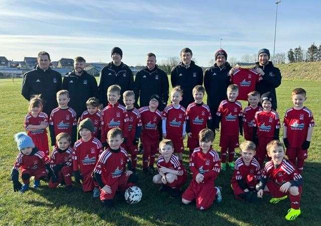 Norlan skipper Nicol Ritchie presents the new strips to the Deveronvale Community Football Club 2018 team.