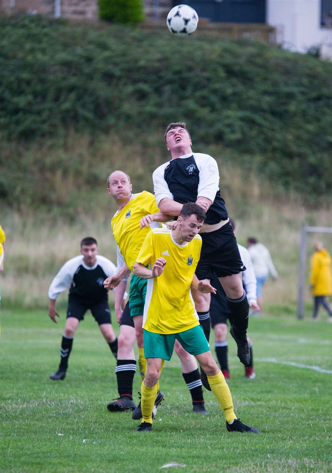 Hopeman's Iain Lunan and Buckie's Jamie Wood challenge for the ball with Ryan Farquhar in front. Picture: Becky Saunderson..